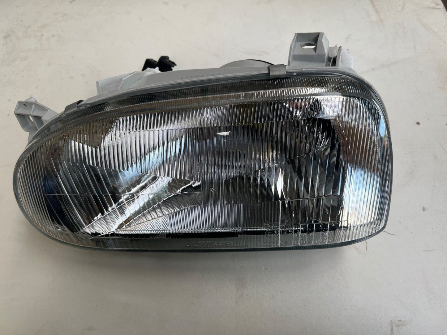 Depo 411-1111L-RD-E Near Side Headlight Lamp
